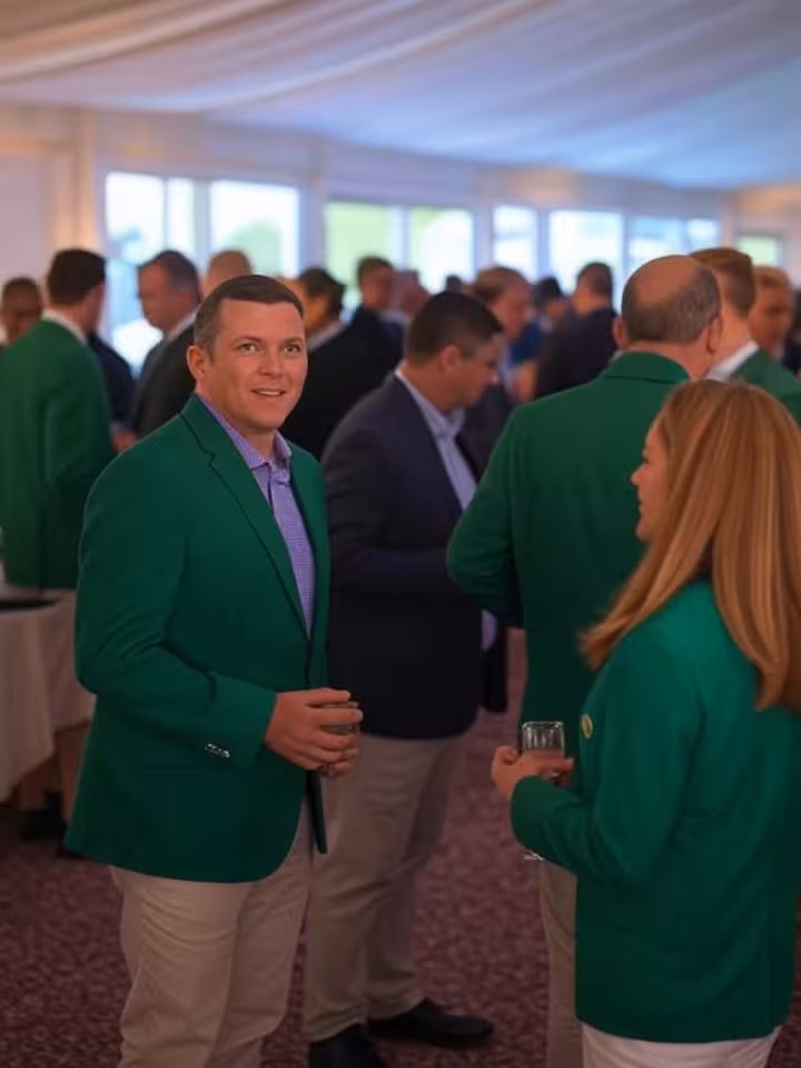 Upscale corporate hospitality tent interior at Masters Tournament, champagne glasses, well-dressed c