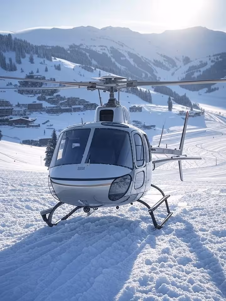 Private helicopter on snowy mountain landing pad with luxury ski resort in background, exclusive wea