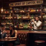 Elegant cocktail bar interior with dim amber lighting, leather booths, extensive back bar with thous