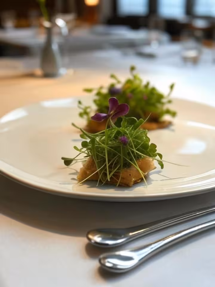Artistic plated fine dining dish with microgreens and edible flowers, minimalist white plate, soft n