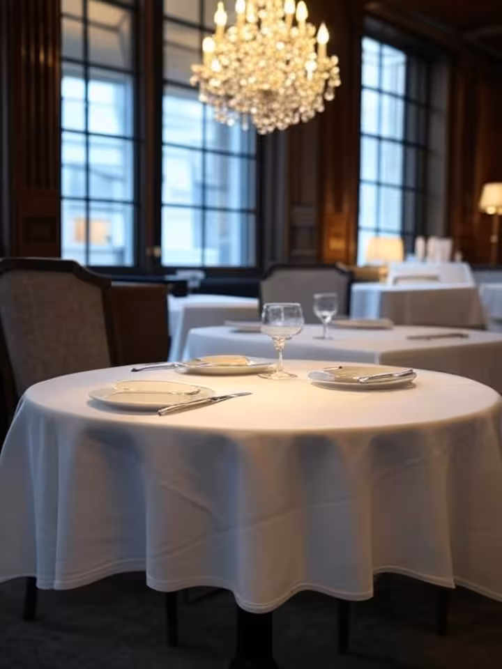 Luxurious French restaurant interior with crystal chandelier, intimate corner table with white table